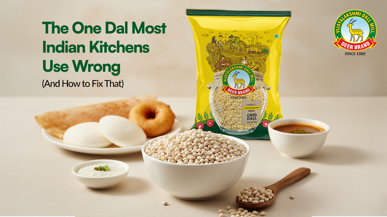 Vijayalakshmi Deer Brand Orid Dal pack placed on a kitchen counter with a bowl of urad dal, idlis, dosa, vada, chutney, and sambar; promotional banner showing the headline ‘The One Dal Most Indian Kitchens Use Wrong’. High-quality food setup highlighting premium urad dal for idli, dosa, and vada preparation.